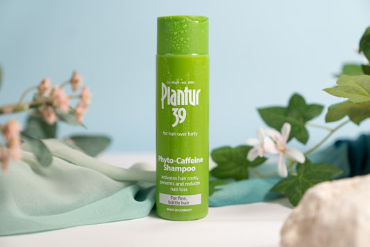 A tube of deodorant next to a plant
